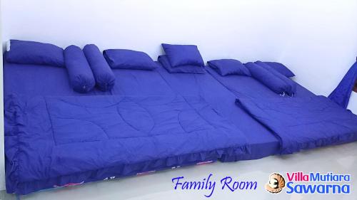 Postel nebo postele na pokoji v ubytování Villa Mutiara Sawarna