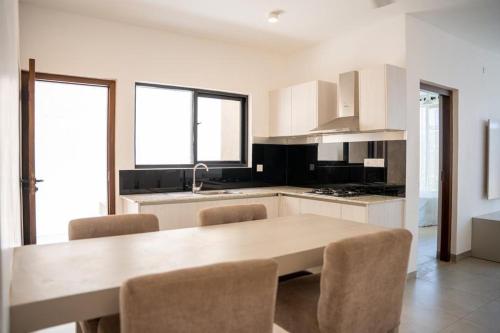 a kitchen with a table and chairs in a room at Charming Villa with Stunning Rooftop Sea View in Mount Lavinia