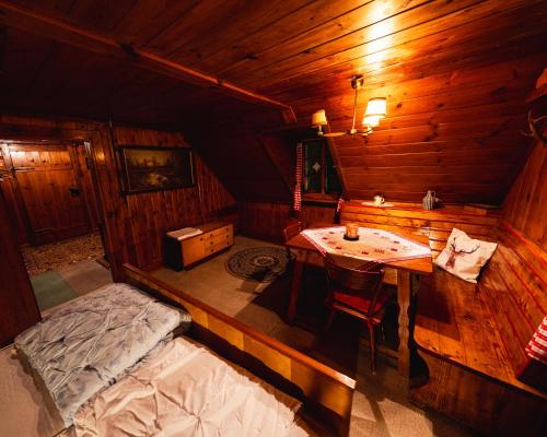 a room with a bed and a table in a cabin at Almhütte am Seeberg in Brandhof