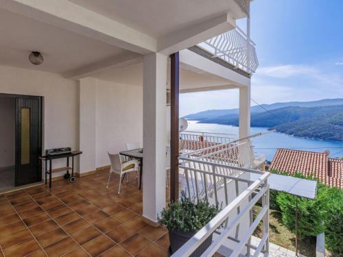 a balcony of a house with a view of the water at Apartment Katarina-1 by Interhome in Rabac