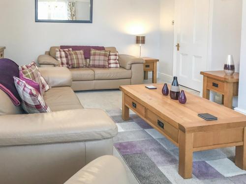 a living room with a couch and a coffee table at Upton Down in Keswick