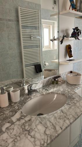 a bathroom with a sink and a mirror at Casa Bonomea in Trieste