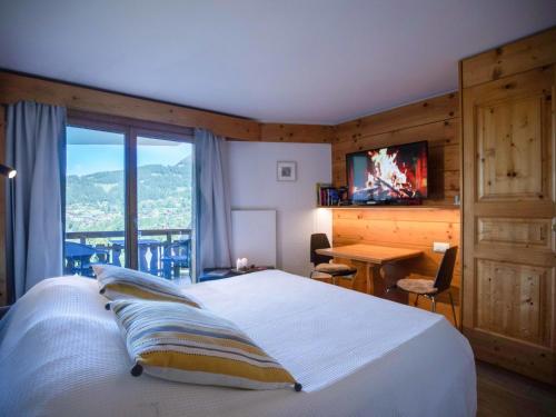 a bedroom with a bed and a desk and a television at Studio Le Bristol A25-31 by Interhome in Villars-sur-Ollon
