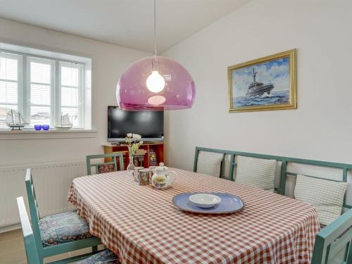 a dining room table with a red and white checkered table cloth at Apartment Delfina - 250m from the sea by Interhome in Hjørring