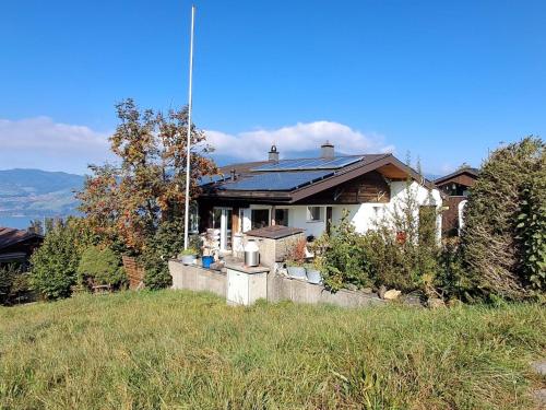 a house sitting on top of a grass field at Apartment Chilis Ferienresidenz by Interhome in Aeschi