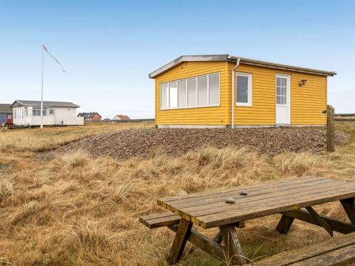 a yellow house with a picnic table in front of it at Holiday Home Nyalle - 50m to the inlet by Interhome in Struer