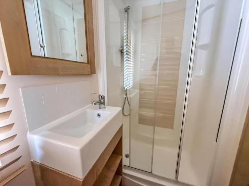 a bathroom with a sink and a shower at 6 Berth Caravan With Decking At Caister Haven Holiday Park Ref 30032P in Great Yarmouth