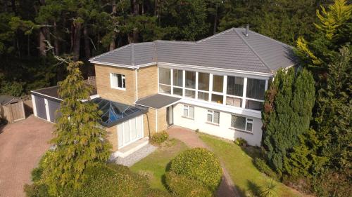 an aerial view of a house with a roof at 5 Bed House - Pool - Hot Tub - Sauna - Pool Table - Near New Forest and Beach - Sleeps 12 in Ringwood