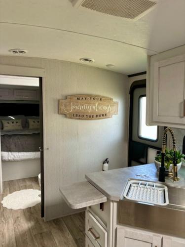 a kitchen in an rv with a sign on the wall at Astoria in Round Top