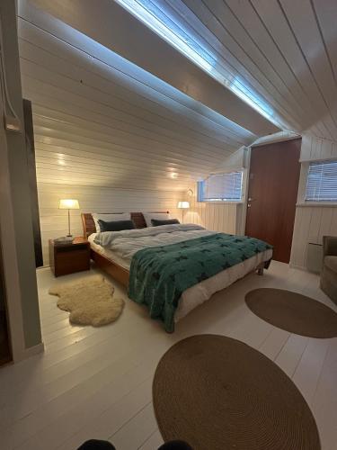 a bedroom with a large bed and two rugs at The Vrådal Pearl in Vradal