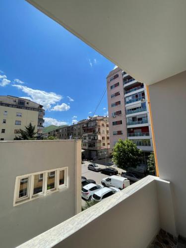 an apartment balcony with a view of a parking lot at Klindi Apartaments in Pogradec