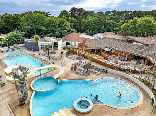 an overhead view of a pool at a resort at Flower Camping Au Bois des Biches in Saint-Hilaire-de-Riez