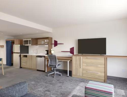 an office with a desk and a television in a room at Home2 Suites By Hilton Chester in Chester