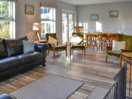 a living room with a couch and chairs and a table at Clarksburn Blue in Monreith
