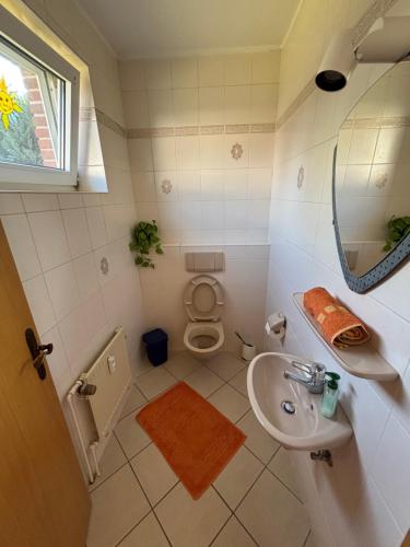a small bathroom with a sink and a toilet at Ihr Kuschelnest in Wathlingen
