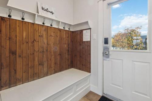 a bathroom with a bench and a window and a door at Alpine Breeze Getaway at Blue in Blue Mountains