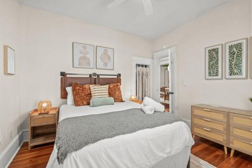 a white bedroom with a large bed and a dresser at Hygge High Point by Rather Be Properties in High Point