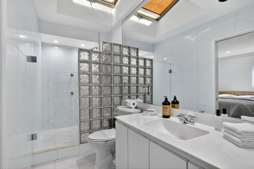 a white bathroom with a sink and a shower at Siena Villas in Pompano Beach
