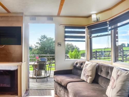 a living room with a couch and a large window at Croft - Uk50042 in Clitheroe