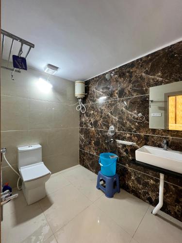 a bathroom with a toilet and a sink at Staeg Shiva in Ujjain