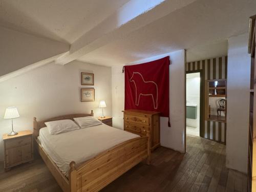 a bedroom with a bed with a red painting on the wall at Les Pounchus D N02 - 3P8 in La Foux d'Allos