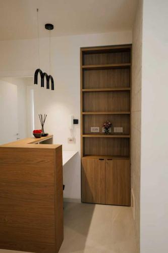 a kitchen with wooden cabinets and a counter top at Atelier Inn Vaticano in Rome