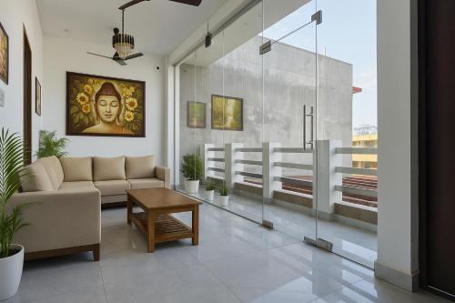 a living room with a couch and a table at Ramayana Grand Hotel Ayodhya - Just Steps Away from Ram Mandir in Ayodhya