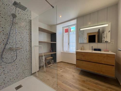 a bathroom with a shower and a sink and a mirror at l'Ancien Bistrot in Saint-Martin-de-Bréthencourt