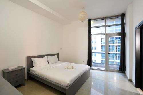 a bedroom with a bed with a stuffed animal on it at Superb Family Friendly Beach-Front Whole Flat, Great Views in Dubai