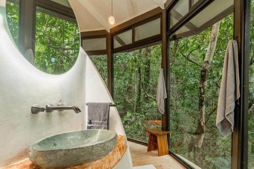 a bathroom with a large stone tub in front of a window at The Nest in San Luis