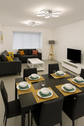 a living room with a table with chairs and a couch at Harry Potter Stay - Watford & London Links - Large Family in Abbots Langley