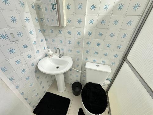 a small bathroom with a sink and a toilet at Pé na areia em Nova Mirim com Wi-Fi e conforto! in Samaritá