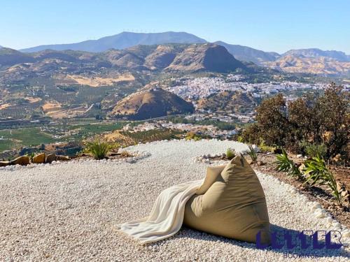 a tent laying on the rocks with a view of the mountains at Alora Private Villa - Pool & 360 Mountain Views in Alora