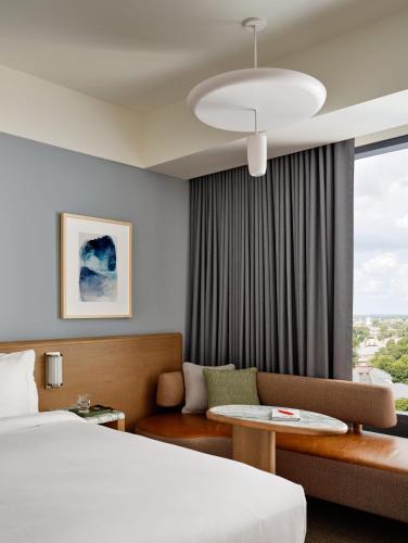 a hotel room with a bed and a couch at The Atlas Hotel in Boston