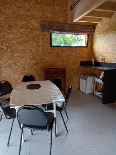 a dining room with a table and chairs at Le Nid in Abbaretz