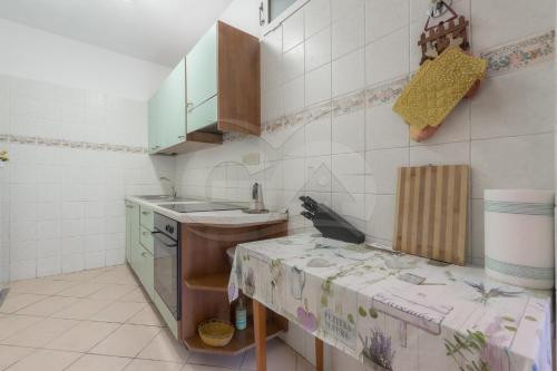 a small kitchen with a sink and a counter at La Casina a Schiopparello - Goelba in Portoferraio