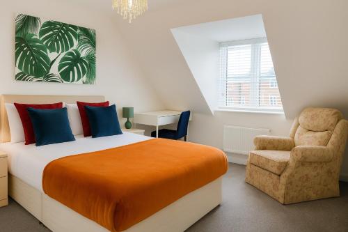 a bedroom with a bed and a chair at Harry Potter Stay with Watford & London Links - Family house in Abbots Langley