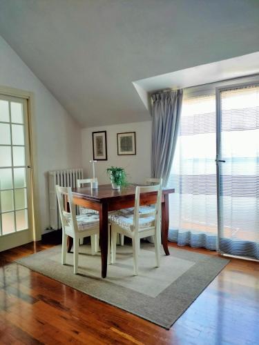 a dining room with a table and chairs and a window at Mansarda DaSy in Ancona
