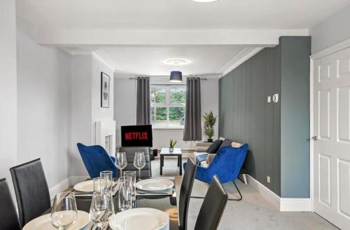 a dining room with a table and blue chairs at 2-Bed Near Lincoln City Centre with Parking in Lincoln
