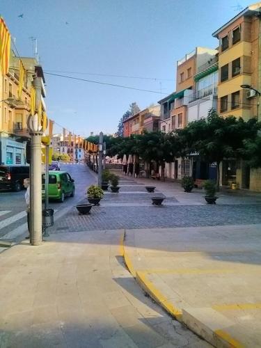 a city street with cars parked on the street at Hostal Pirineos in Barbastro