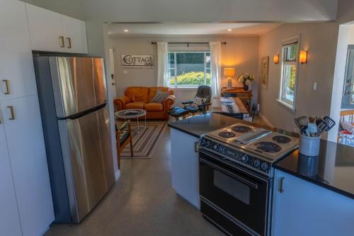 a kitchen with a stove and a refrigerator at Family Cottage at Horner Park in Victoria