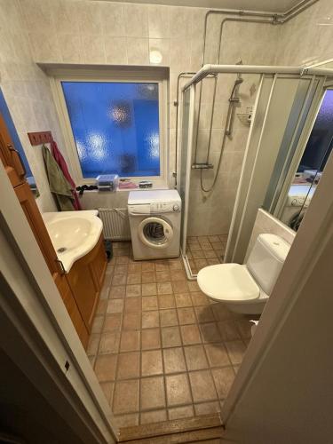 a bathroom with a shower sink and a toilet at Central accommodation in Umeå