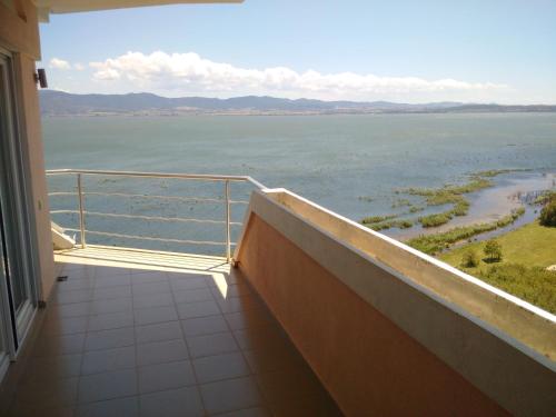 a balcony with a view of the water at Villa Daniela Apartments in Nov Dojran