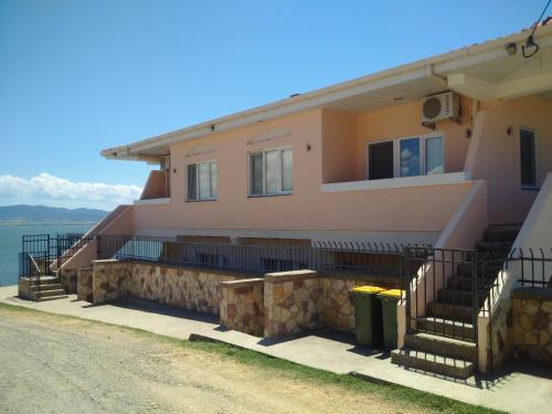a house on the side of a road at Villa Daniela Apartments in Nov Dojran