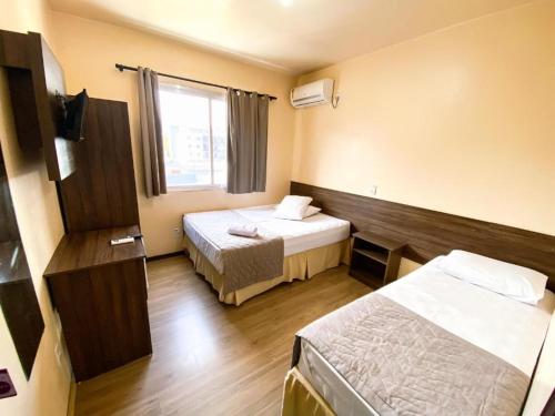 Postel nebo postele na pokoji v ubytování Hotel Zata - Econômico