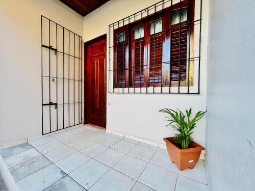 a room with a door and a potted plant at Casa ao lado do Sebrae in Macapá