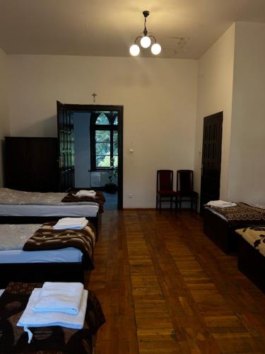 a room with several beds in it with a window at Nostra Cultura Zamek Bierzgłowski in Zamek Bierzgłowski