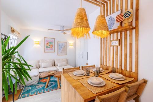 a living room with a table and chairs and a couch at Casa Phoebe - NEW Renovated Burgau Apartment Sleeps 5 - Beach 1 min in Burgau