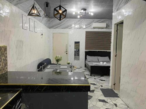 a bathroom with a tub and a bed in a room at CASA Sapphira Transient House in Santo Tomas