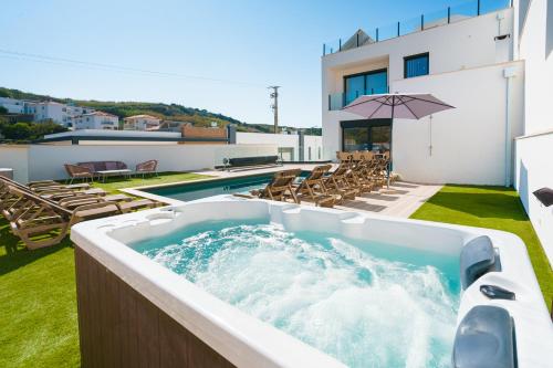 a hot tub on the roof of a house at Antica Villa, luxury villa near the beach in Ribamar
